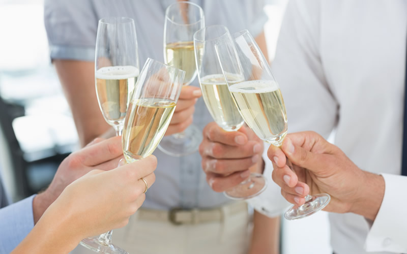group of people toasting with champagne