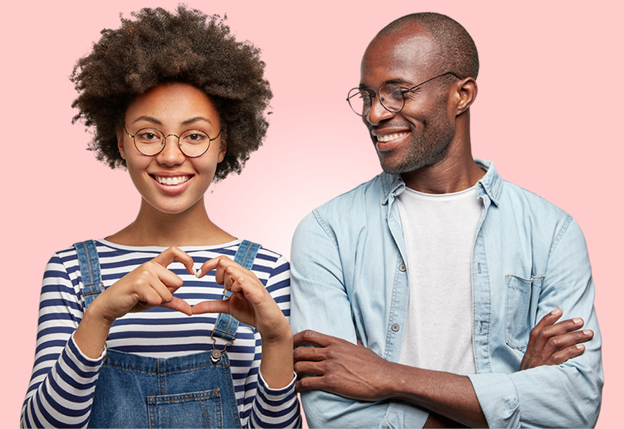 Young black couple with woman making a heart sign